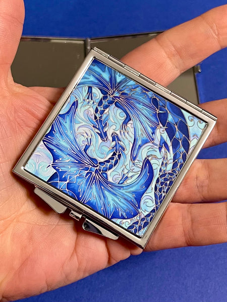 Blue dragon square mirror for, pocket, handbag, purse or desk drawer. Open the metal case to reveal two mirrors. Check your make up any time you need to.