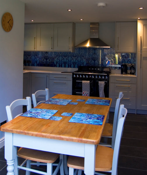 Blue Stag square table mats and matching coasters - hard wearing durable mats - 28x28cm  placemats in blue and aqua -gift for woodland, forest, tree and wildlife lovers. 
Square Stag place Mat - Stag Table Mats and Coasters 
Full wall stag glass splashback in background.